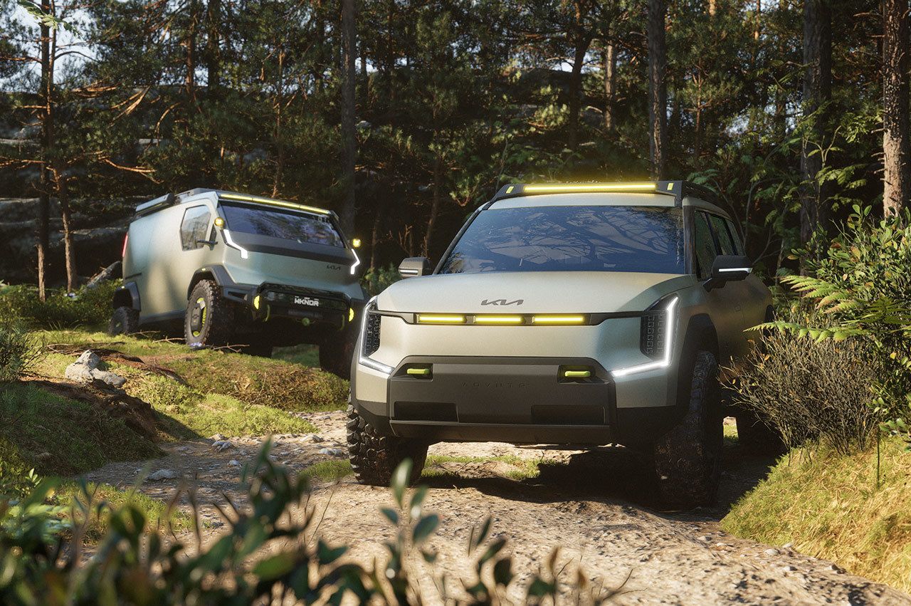 Kia EV9 "ADVNTR" concept vehicle driving over rocky terrain ahead of the Kia PV5 "WKNDR" concept vehicle in the mountains