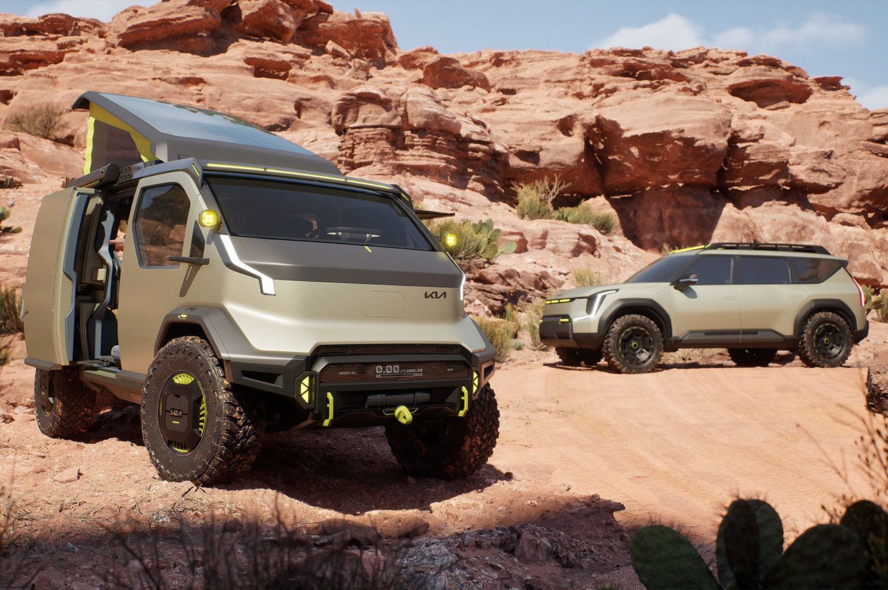 Kia "WKNDR" concept EV van parked adjacent to the Kia "ADVNTR" concept vehicle near the desert canyons