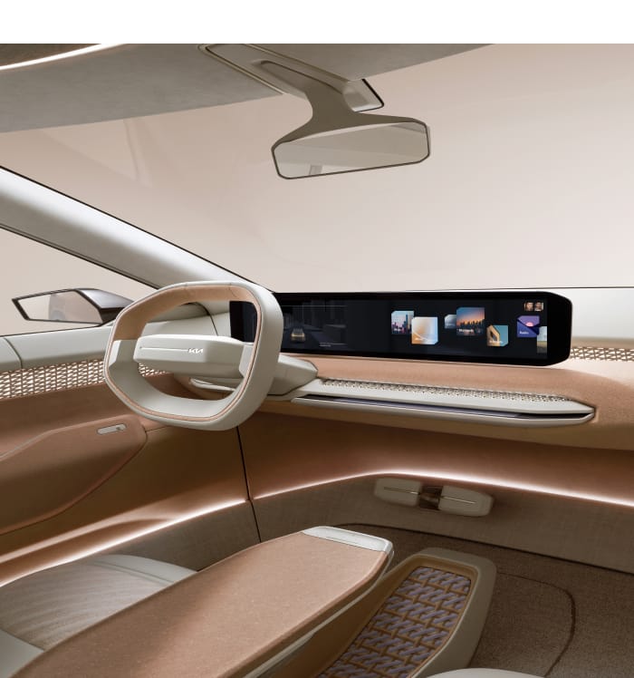 Kia EV4 concept vehicle interior, driver seat view with neutral colored cotton accents, featuring a driver centric instrument panel
