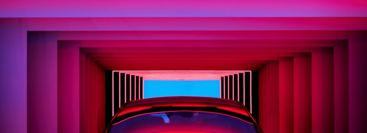 Background image of a rocky mountain top with the sun rising behind another faraway mountain