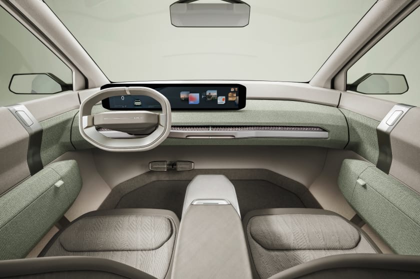 Kia EV3 concept vehicle interior, driver and passenger view, featuring a minimalist, clean design.